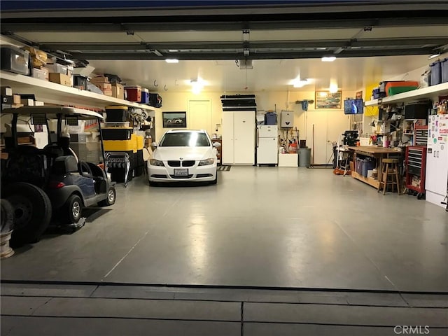 garage with a garage door opener and white fridge