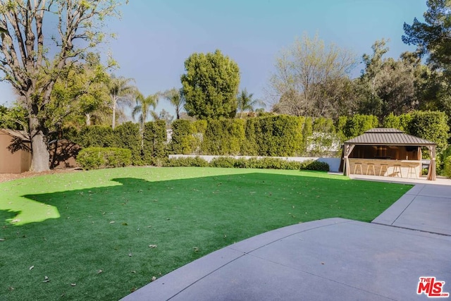 view of yard with a patio area, a gazebo, and a bar