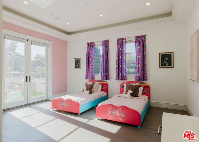 bedroom with access to outside, french doors, dark hardwood / wood-style floors, and a tray ceiling