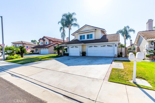 view of front of house featuring a front lawn and a garage