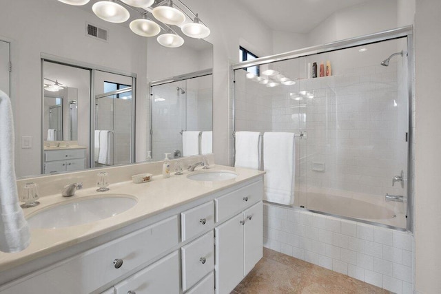 bathroom with combined bath / shower with glass door, vanity, ceiling fan, and tile patterned flooring