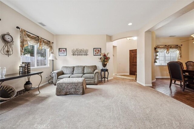 carpeted living room featuring ceiling fan and plenty of natural light