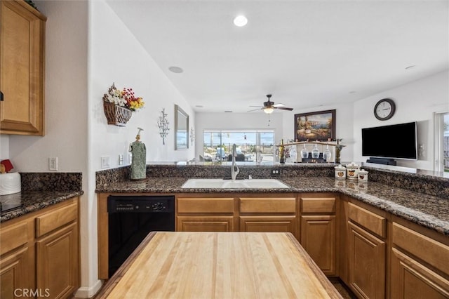 kitchen featuring ceiling fan, butcher block counters, sink, and black dishwasher