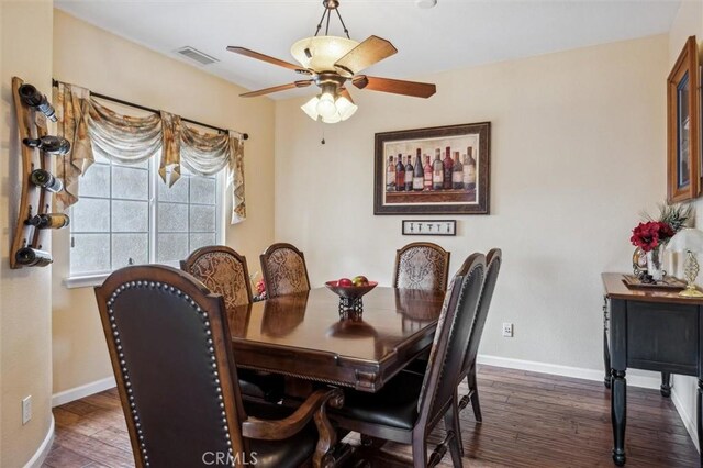 dining space with ceiling fan and dark hardwood / wood-style flooring