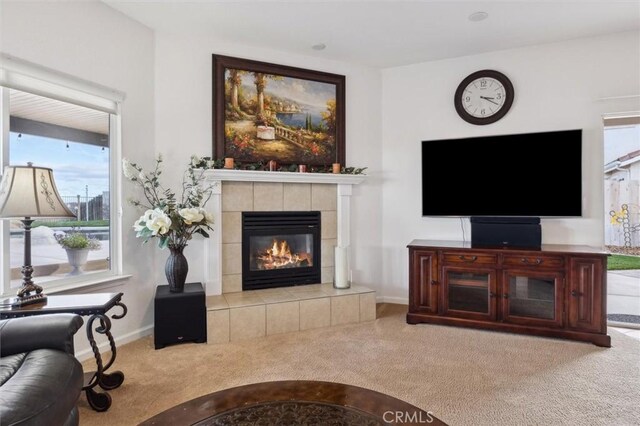 living room with carpet floors and a tile fireplace