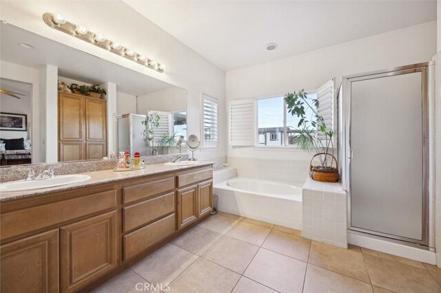 bathroom featuring independent shower and bath, tile patterned floors, and vanity