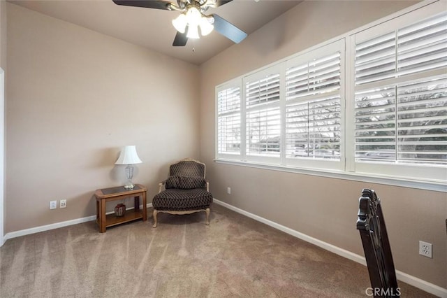 living area with ceiling fan and light colored carpet