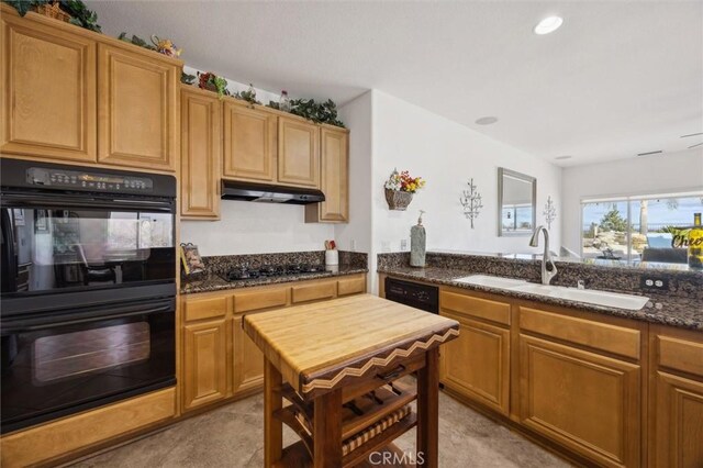 kitchen with black appliances, light tile patterned floors, dark stone counters, and sink