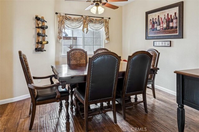 dining space featuring dark wood-type flooring and ceiling fan