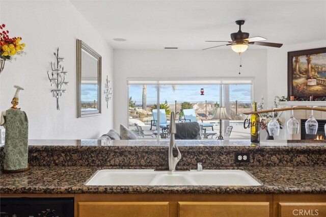 interior space featuring ceiling fan and sink