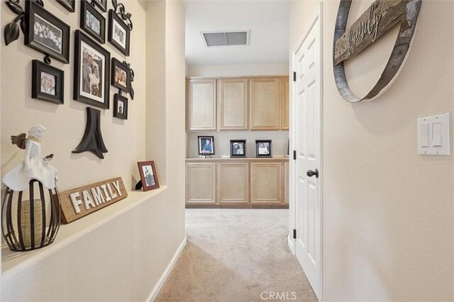 corridor with light colored carpet