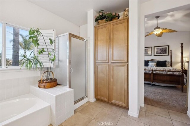 bathroom with ceiling fan, independent shower and bath, and tile patterned floors