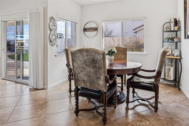 dining space featuring light tile patterned floors