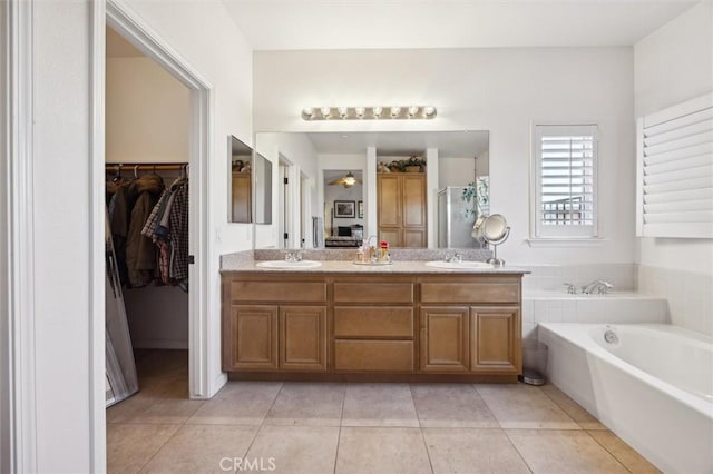 bathroom featuring tile patterned flooring, separate shower and tub, and vanity