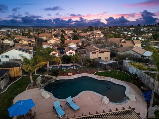 view of pool at dusk