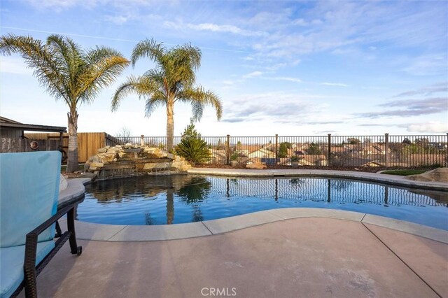 view of swimming pool with a patio area