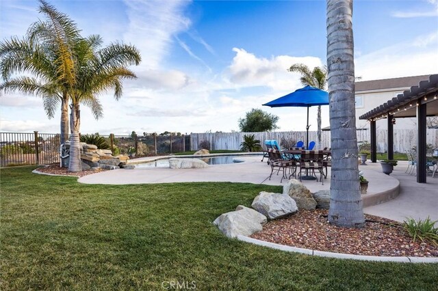 view of yard with a patio and a fenced in pool