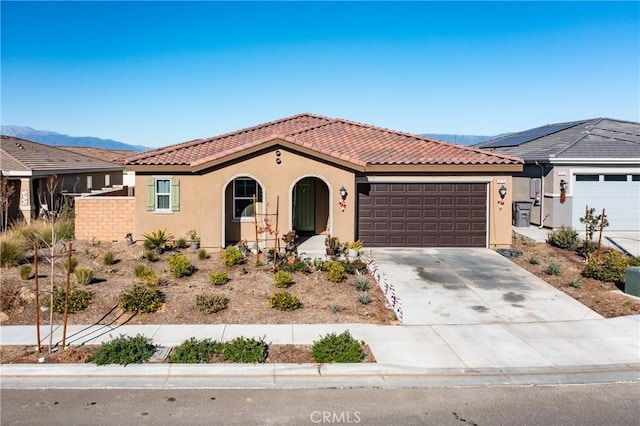 view of front facade featuring a mountain view and a garage