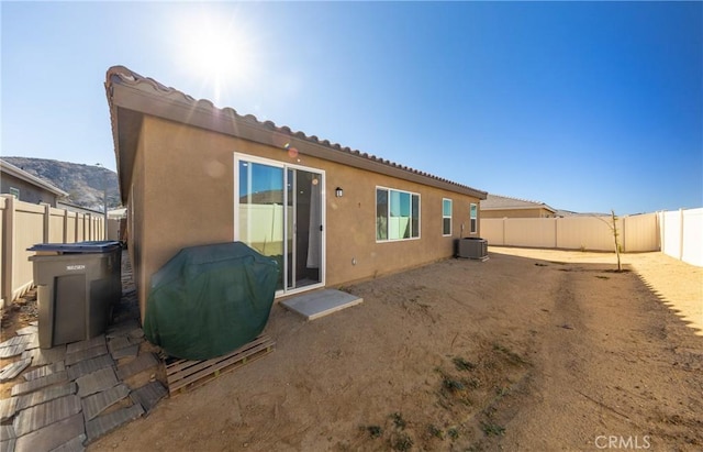 back of house with central AC and a patio