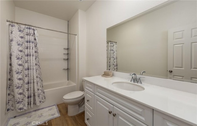 full bathroom with hardwood / wood-style floors, toilet, vanity, and shower / tub combo