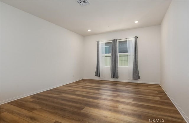 spare room featuring dark wood-type flooring