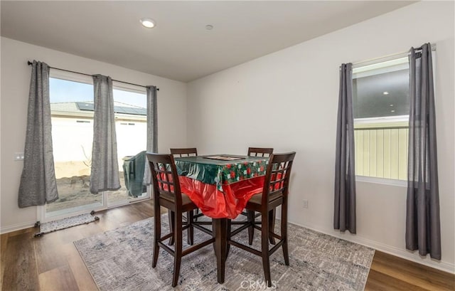 dining area with dark hardwood / wood-style flooring