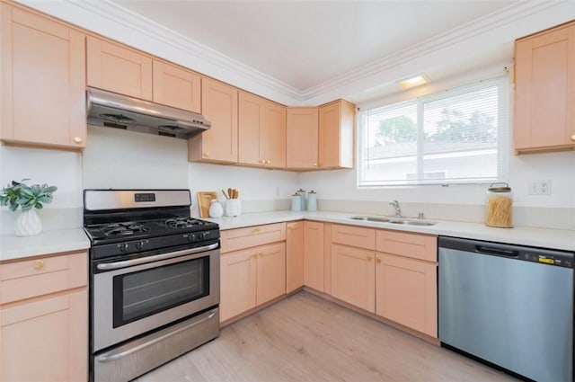 kitchen featuring appliances with stainless steel finishes, light brown cabinets, crown molding, light hardwood / wood-style flooring, and sink