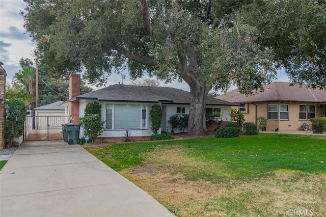 ranch-style home featuring a front lawn and a garage