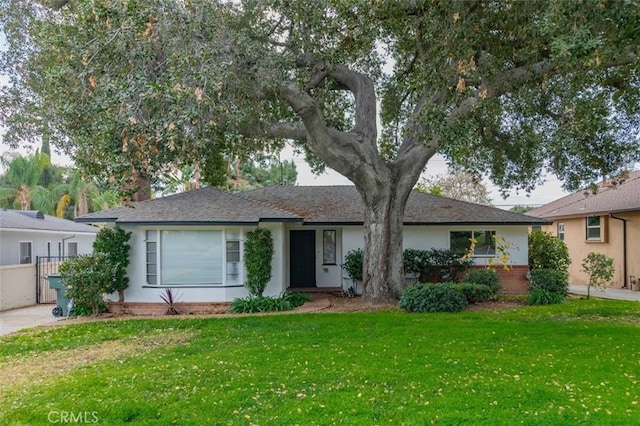 ranch-style home with a front lawn