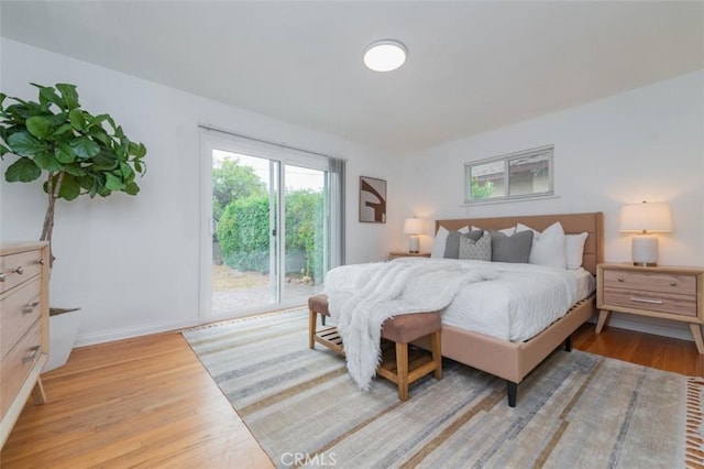 bedroom featuring light hardwood / wood-style flooring and access to outside