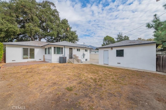 back of house featuring a yard and central AC