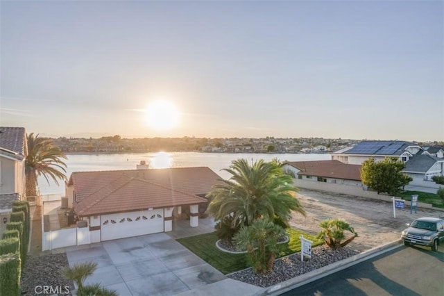 aerial view at dusk with a water view