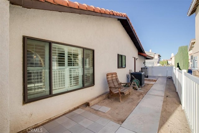 view of property exterior featuring central AC unit and a patio area