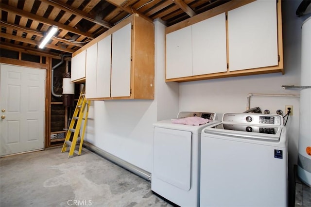 clothes washing area with cabinets and independent washer and dryer