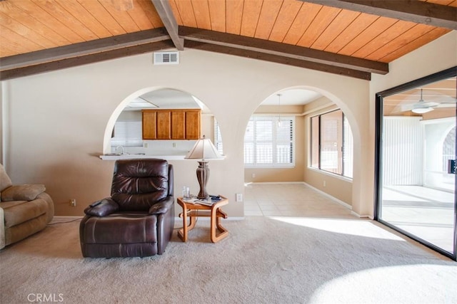 sitting room featuring light colored carpet, wood ceiling, and vaulted ceiling with beams