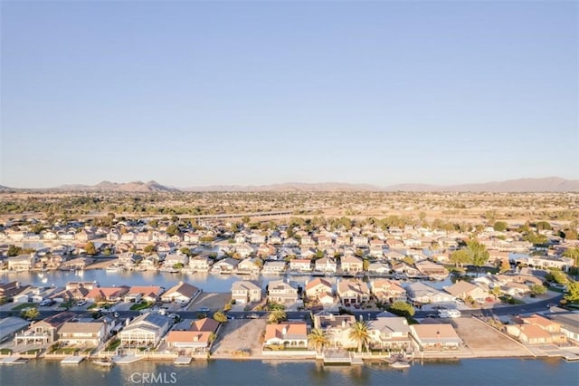 drone / aerial view featuring a water and mountain view