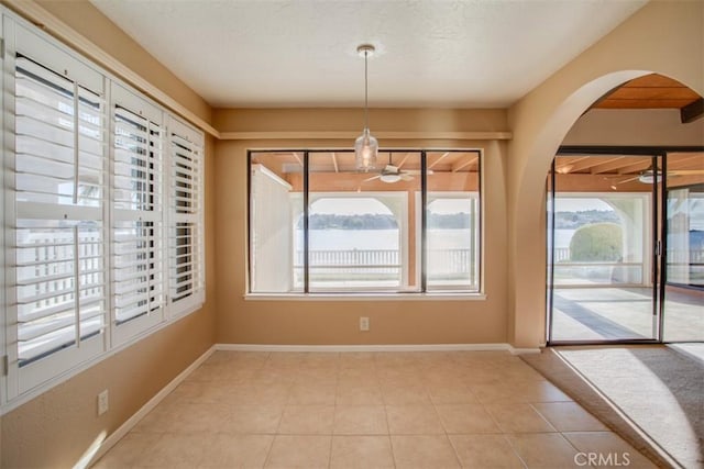 unfurnished dining area featuring a wealth of natural light and light tile patterned floors