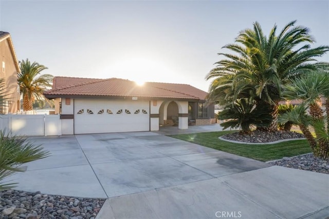 mediterranean / spanish home featuring a garage