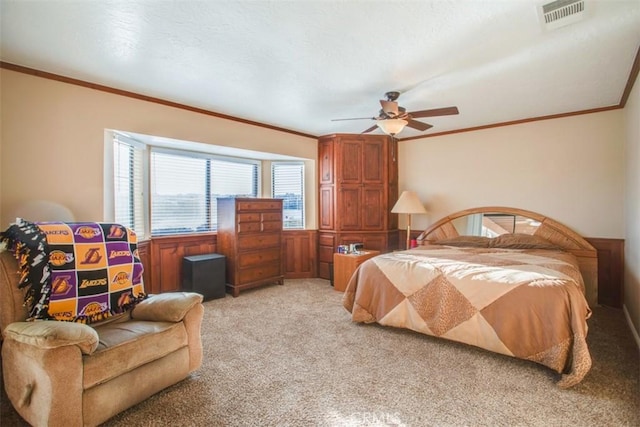 carpeted bedroom with ceiling fan and ornamental molding