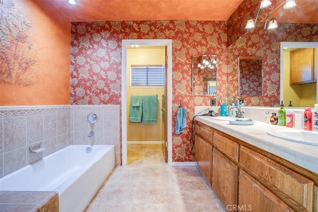 bathroom with vanity, tile patterned flooring, and a bath