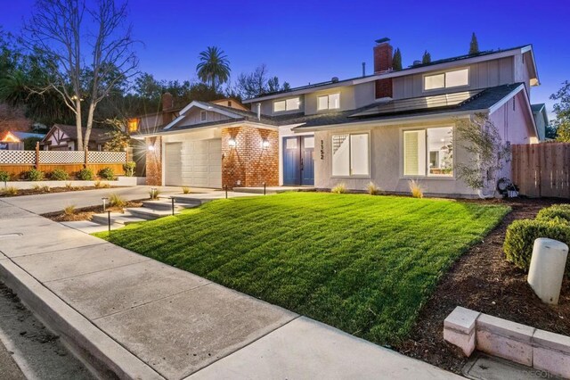 view of front of house with a lawn and a garage