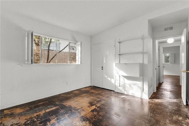 unfurnished bedroom featuring multiple windows