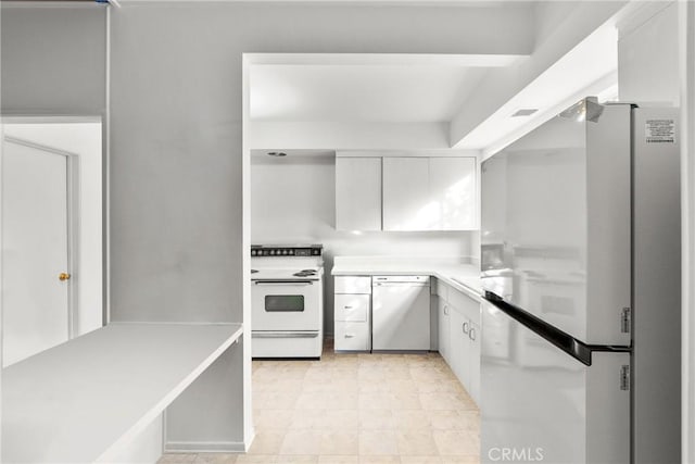 kitchen with white cabinetry and white appliances