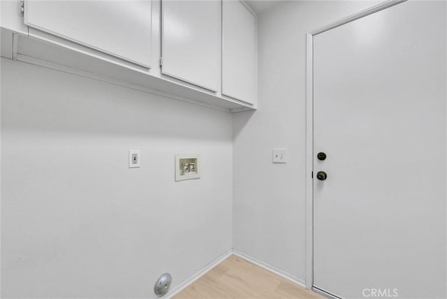 clothes washing area featuring cabinets and hookup for a washing machine