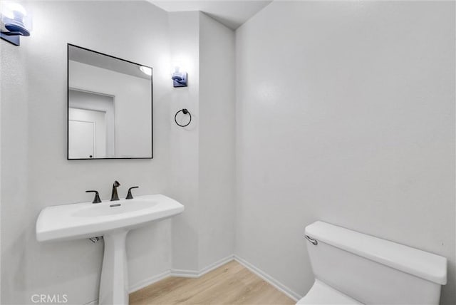 bathroom featuring toilet and hardwood / wood-style flooring