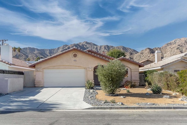 view of front of home with a garage and a mountain view