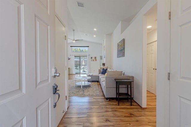 foyer entrance with lofted ceiling and hardwood / wood-style floors