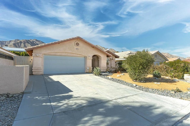 view of front of property featuring a garage and a mountain view