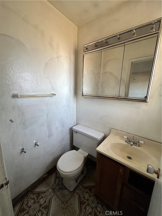 bathroom with toilet and vanity