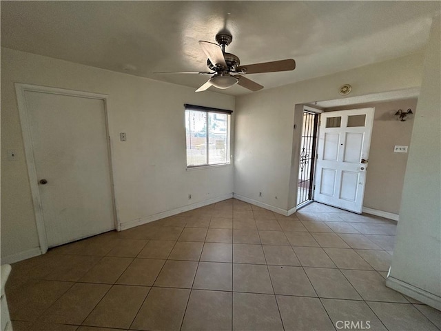 entryway with ceiling fan and light tile patterned floors